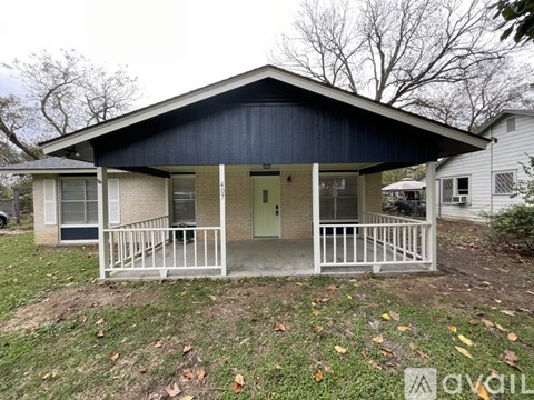A small house with a porch and a covered entrance.