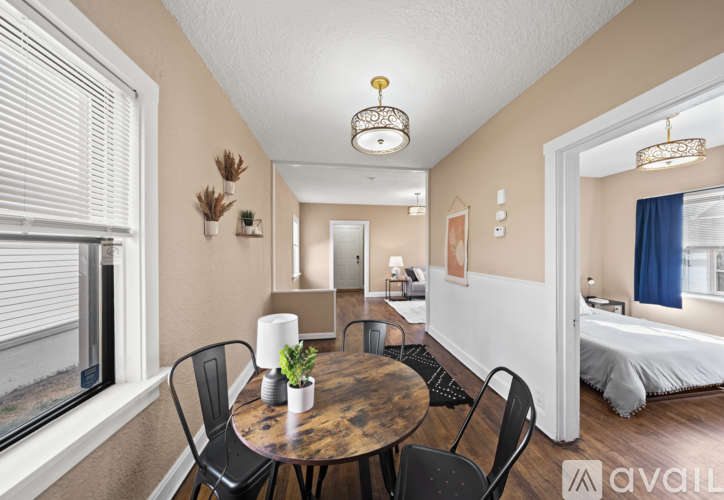 A living room with a dining table and chairs.