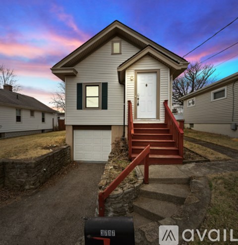 A house with a white door and a red staircase leading to the entrance.