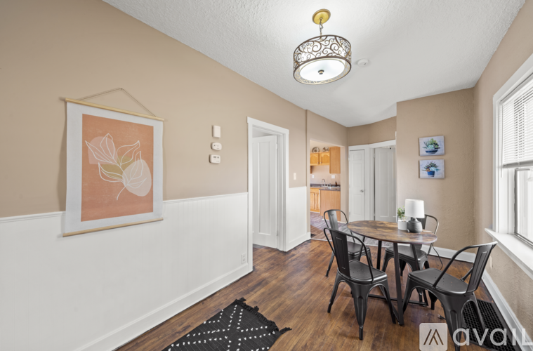 A dining room with a table and chairs.