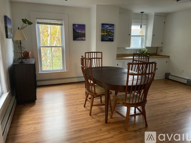 A dining room with a table and chairs.