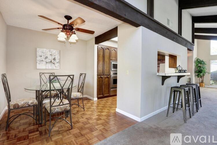 A dining room with a table set for four.