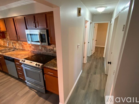 A kitchen with a stove top oven and microwave above it.