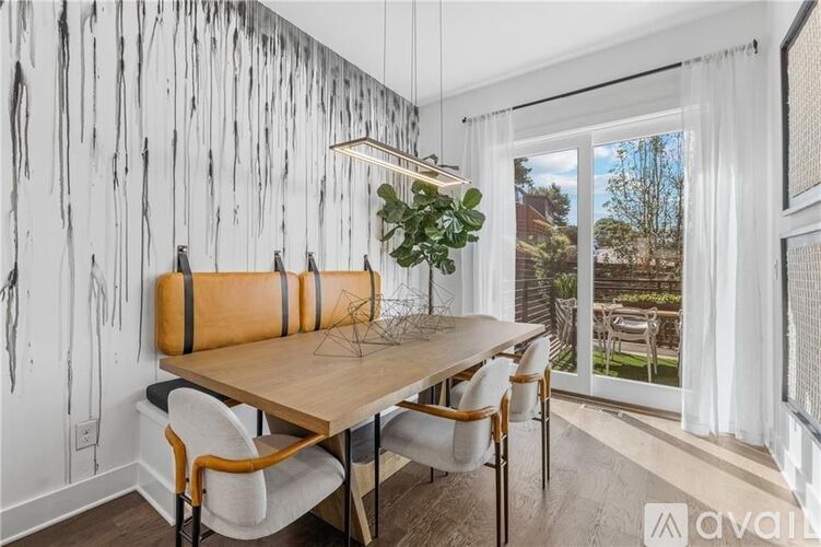 A dining room with a wooden table and chairs.