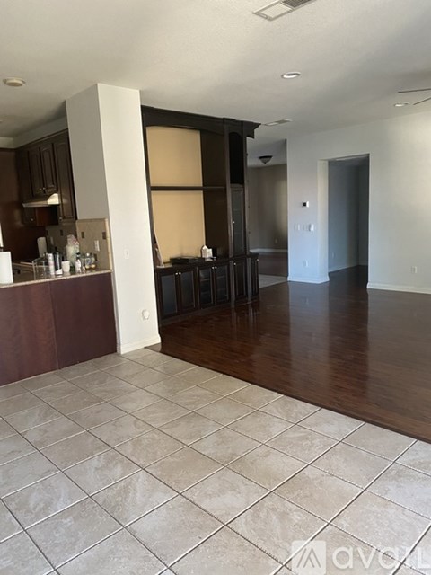 A kitchen area with a bar and a dining table.