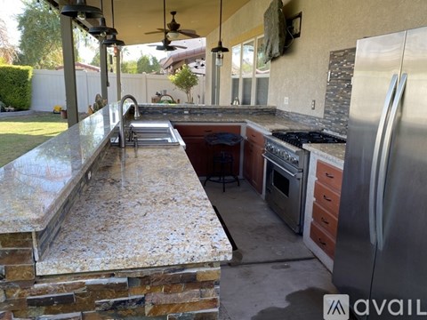 A kitchen with granite countertops and stainless steel appliances.