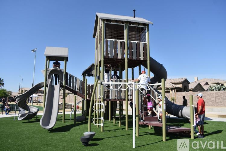 A playground with a large slide and a tower-like structure.