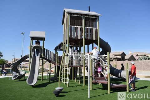 A playground with a large slide and a tower-like structure.