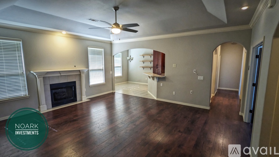 A living room with wood floors and a fireplace is available for purchase.