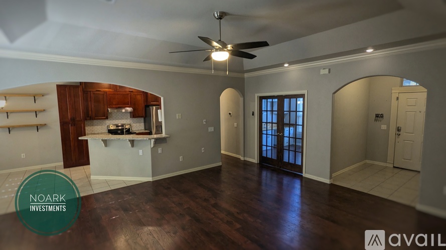 A spacious room with wood flooring and a ceiling fan is available for investment.