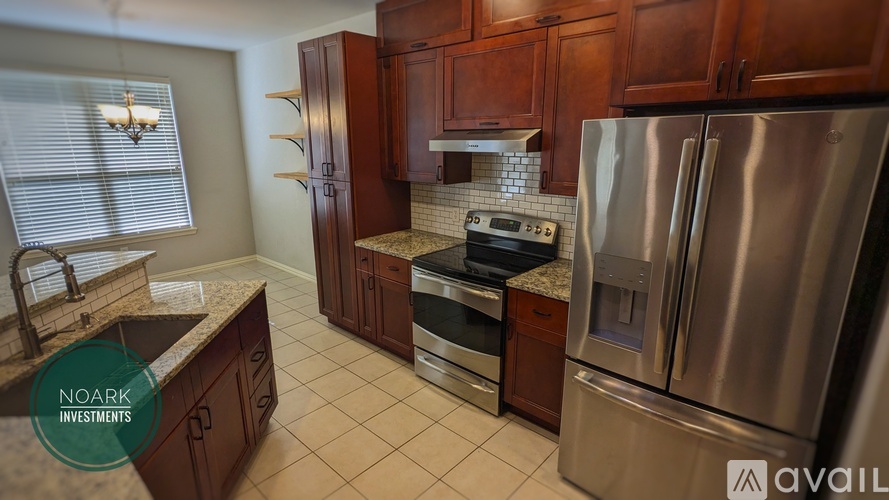 A kitchen with wooden cabinets and stainless steel appliances is available for investment.