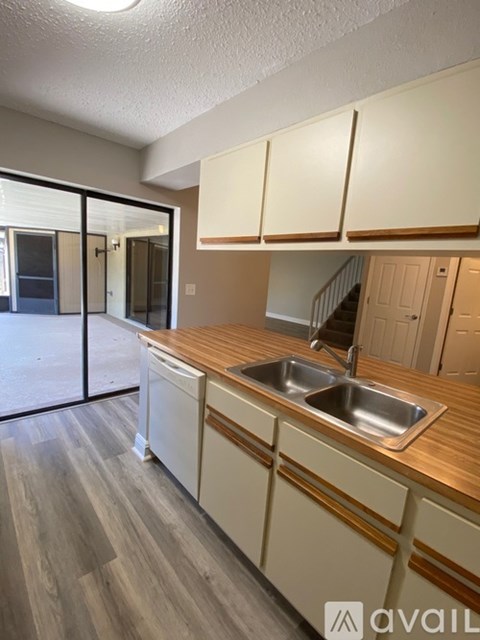 A kitchen with wooden cabinets and a sink.