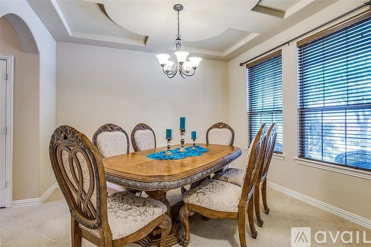 A dining room with a wooden table and chairs.