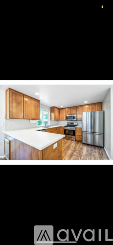 A kitchen with wooden cabinets and a white countertop.