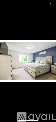 A bedroom with a bed and a window.