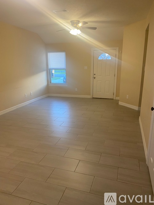 A room with a tiled floor and a ceiling fan.