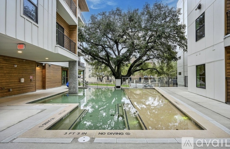 A pool with a sign that says "NO DIVING" is in the foreground of a courtyard.