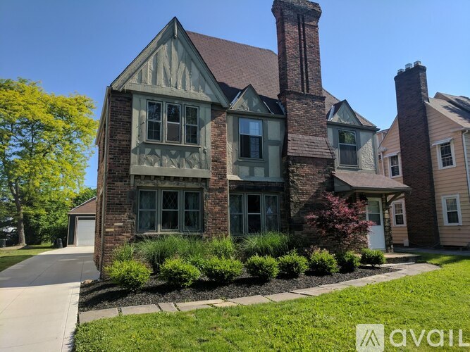 A house with a large front yard and a chimney.