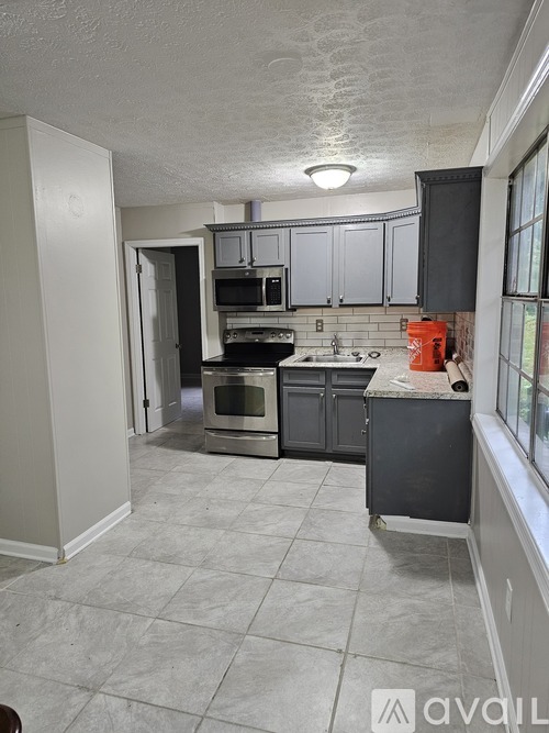 A kitchen with a stove top oven and a microwave.