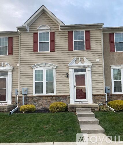 A house with a red door and white windows.