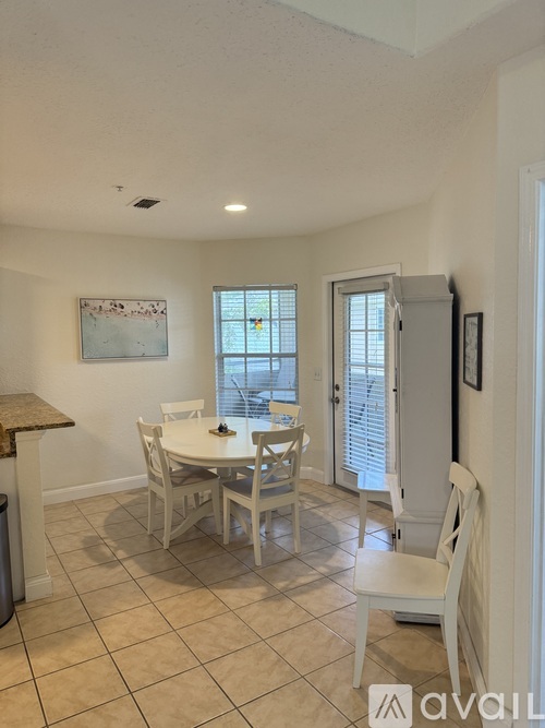 A dining room with a table and chairs.