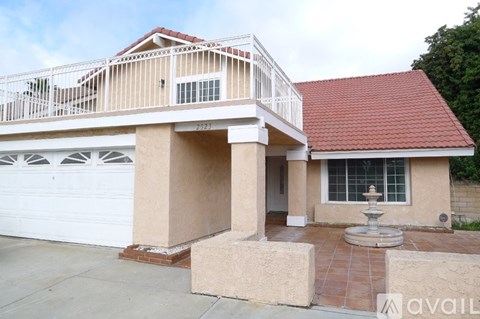 A house with a red roof and a balcony.