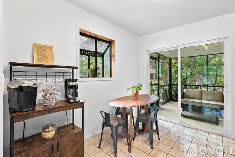 A dining area with a table and chairs is shown.