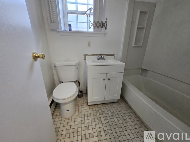 A white toilet and sink in a small bathroom.