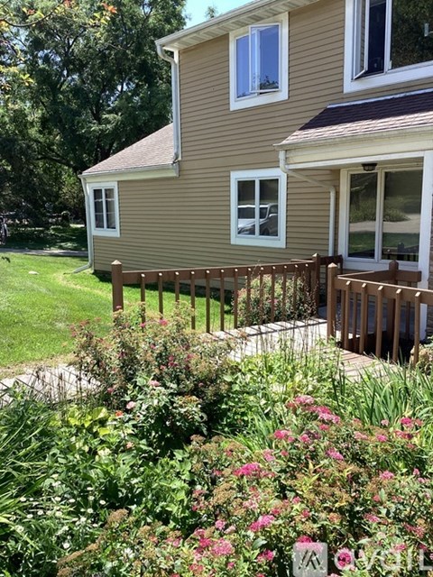 A house with a brown fence and a garden in front.
