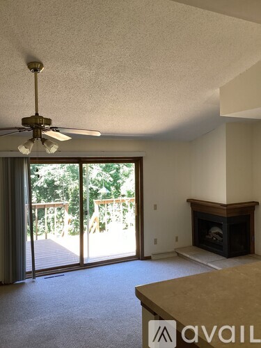 A living room with a fireplace and sliding glass doors.