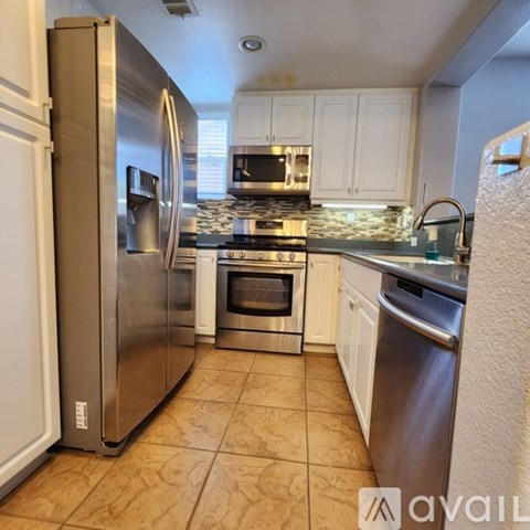 A kitchen with a stainless steel refrigerator and other appliances.