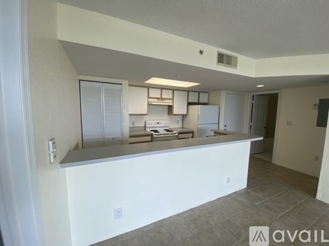 A kitchen area with a counter and cabinets is available for rent.