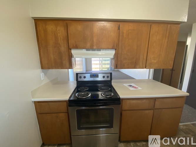 A kitchen with wooden cabinets and a black stove top oven.