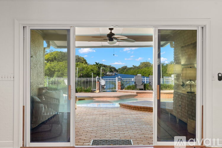 A view from a doorway looking out to a pool area.