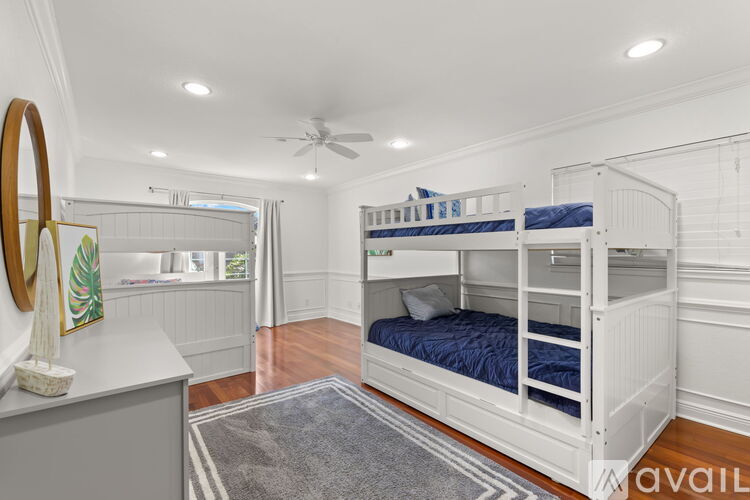 A bedroom with a bunk bed and a dresser.