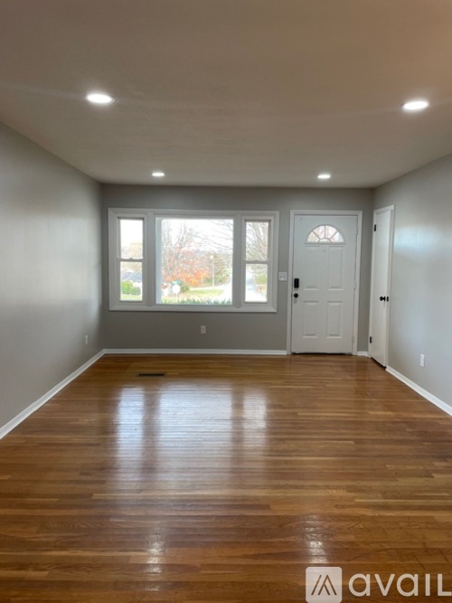 A room with wooden floors and white walls.