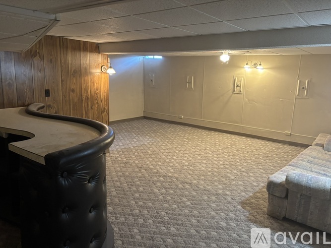 A room with a pool table and a bench.