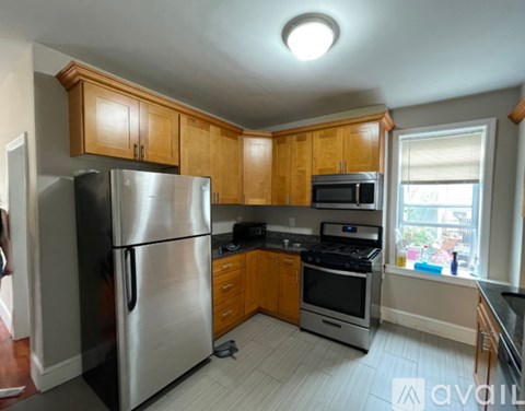 A kitchen with wooden cabinets and stainless steel appliances.