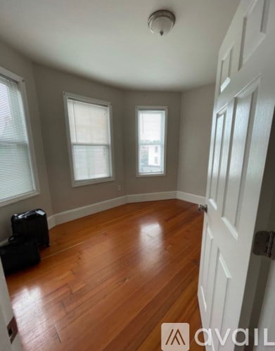 A room with wooden floors and white walls.