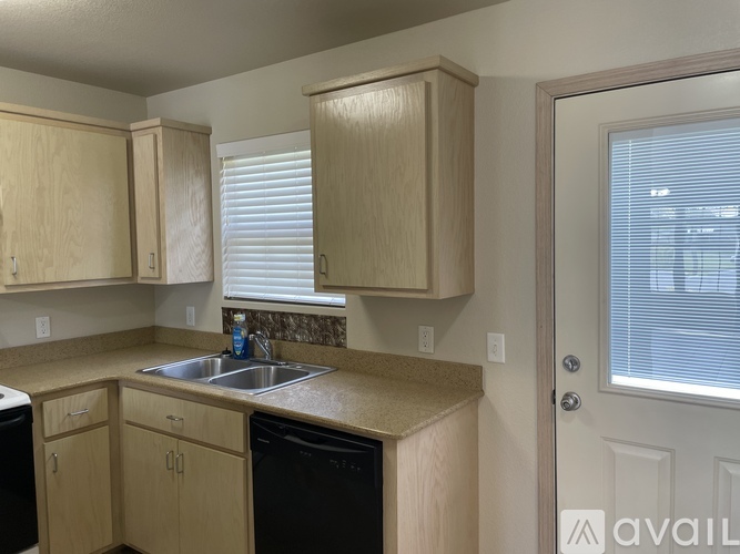 A kitchen with wooden cabinets and a sink.