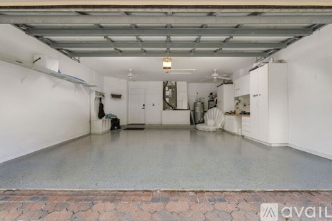 A spacious garage with a brick border at the bottom.