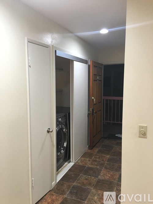 A white door with a glass window is open.
