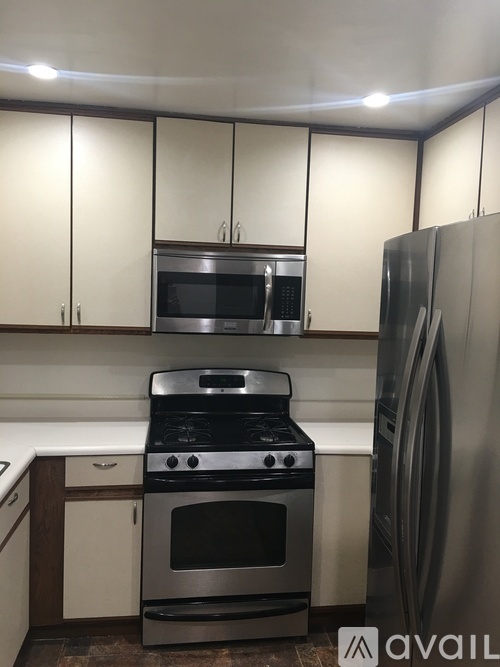 A kitchen with a stainless steel refrigerator and oven.