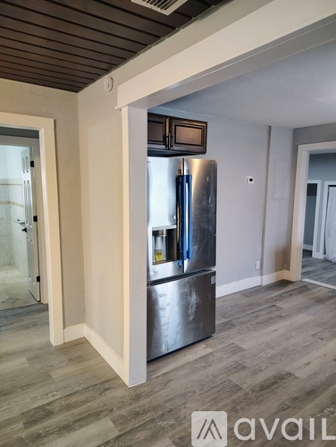 A modern kitchen with a stainless steel refrigerator.