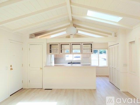 A spacious kitchen with white cabinets and a large island.