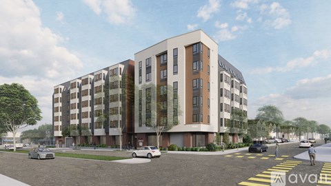 A modern apartment building with cars parked in front.