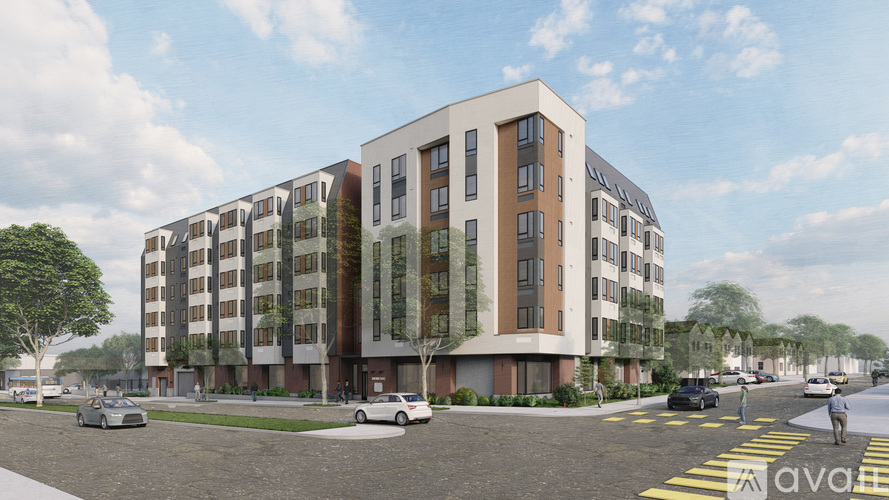 A modern apartment building with cars parked in front.