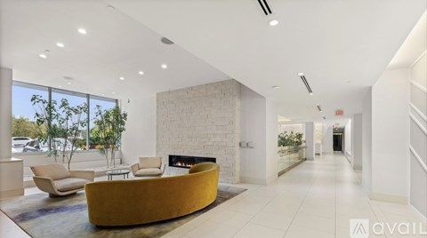 A modern living room with a yellow sofa and a fireplace.