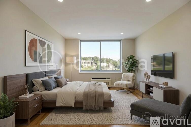 A modern bedroom with a large bed, a chair, and a television.