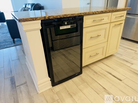 A black oven with a glass door is built into a kitchen counter.